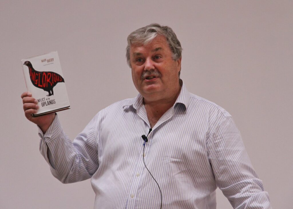 author holding book