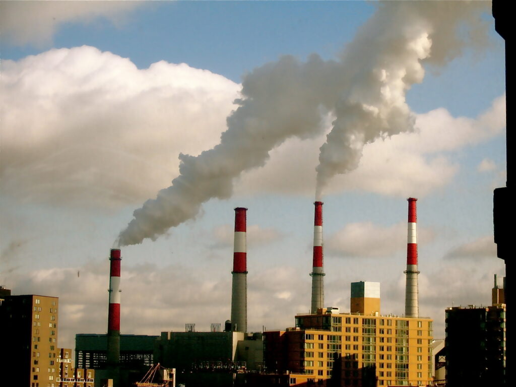 Chimneys spewing smoke from a powerplant.