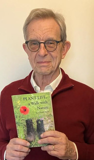 Edward Bent, author of Plant-Life, stood wearing a red jumper holding his book.
