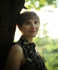 Chantal Lyons, author or Groundbreakers, stood against a tree.