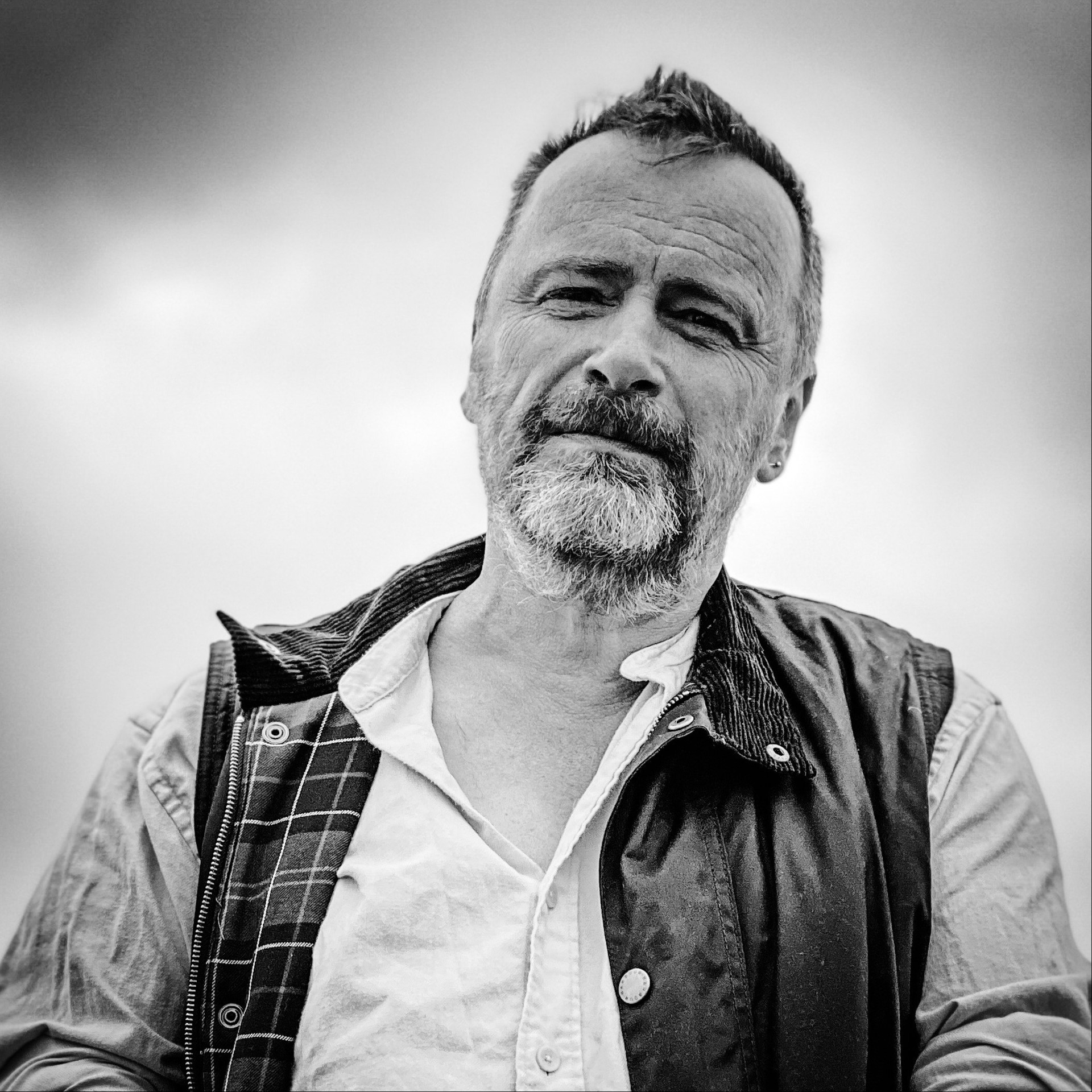 Hugh Warwick, author of Cull of the Wild, in a black and white photo wearing a shirt and gilet.