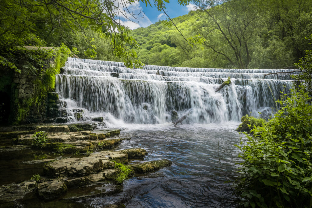 A rocky waterfall surrounded by forest